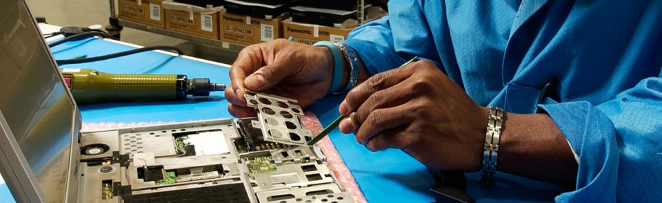 man in a blue shirt completing his IT repair work